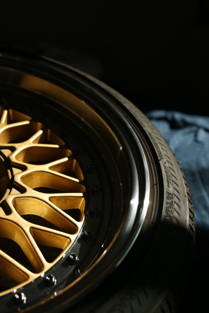 A black tire with golden rim